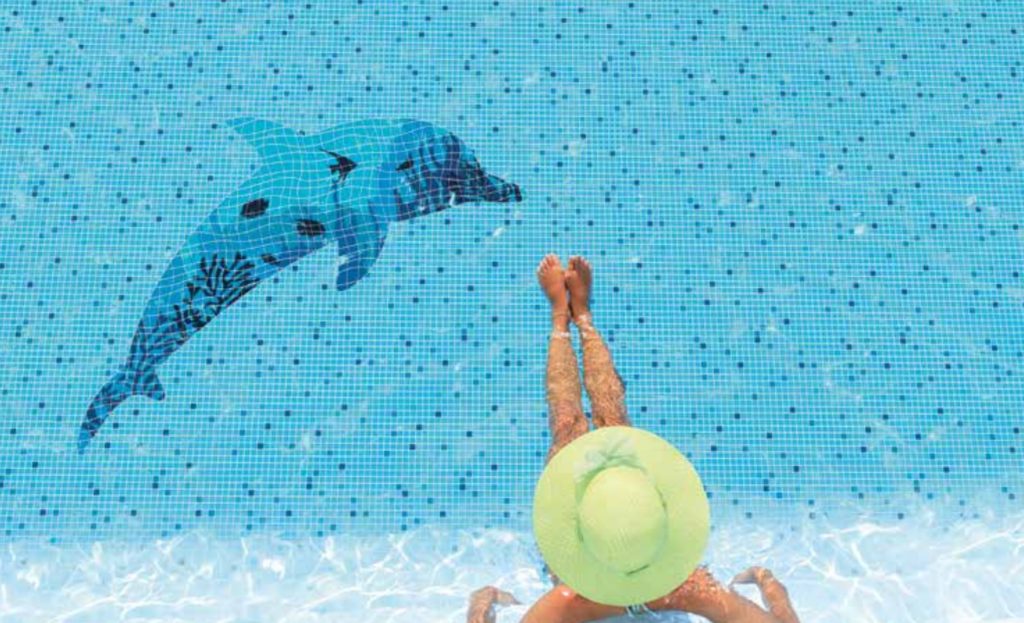 Batik Mosaics on swimming pool floor blue and light blue tiles and dolphin