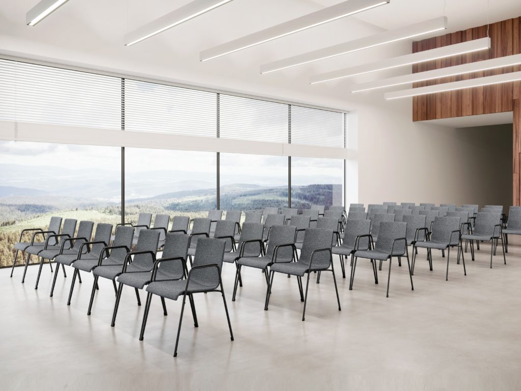 Claudio Bellini Liz-M chair many gray chairs in open auditorium with a view of spacious countryside through window