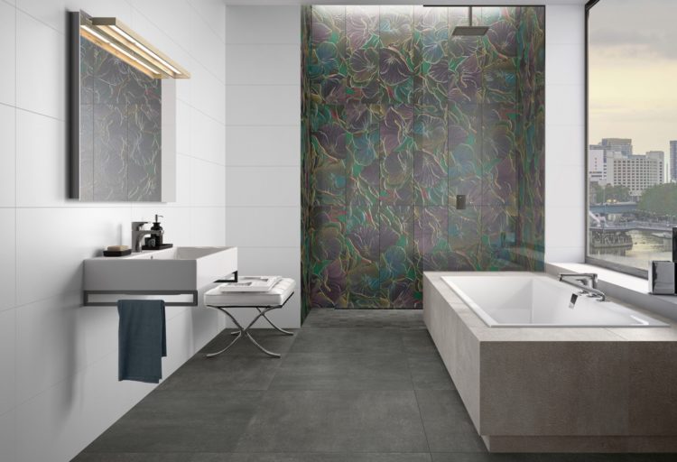 Art of Simplicity tile collection with gray tile with iridiscent color sprinkled throughout in modern bathroom with sink and tub visible