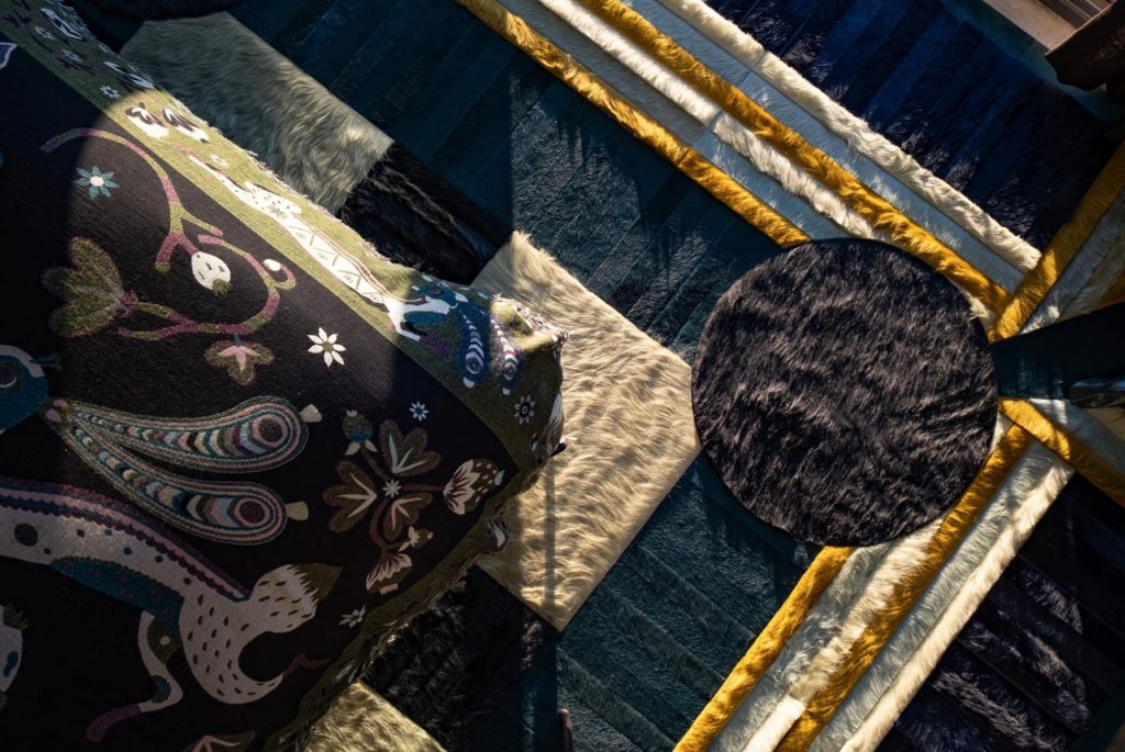 Atlas Collection overhead partial shot of rug with dark tones, blue, black, white, and yellow