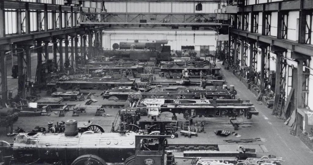 LocHal Library image of original building interior with locomotives and locomotive parts