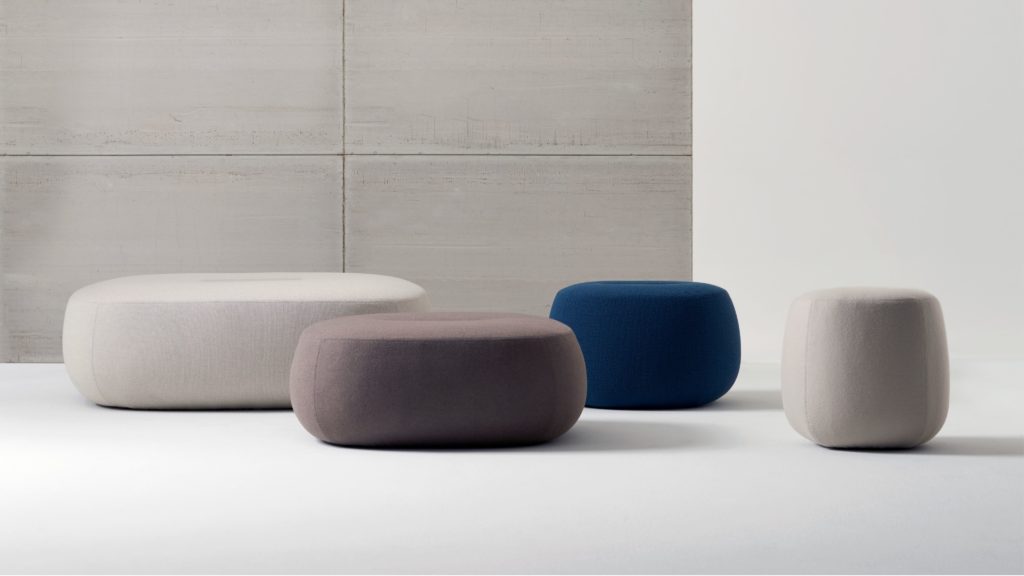 Rho Ottomans medium-wide view of four ottomans, two white, one gray/brown, and one blue