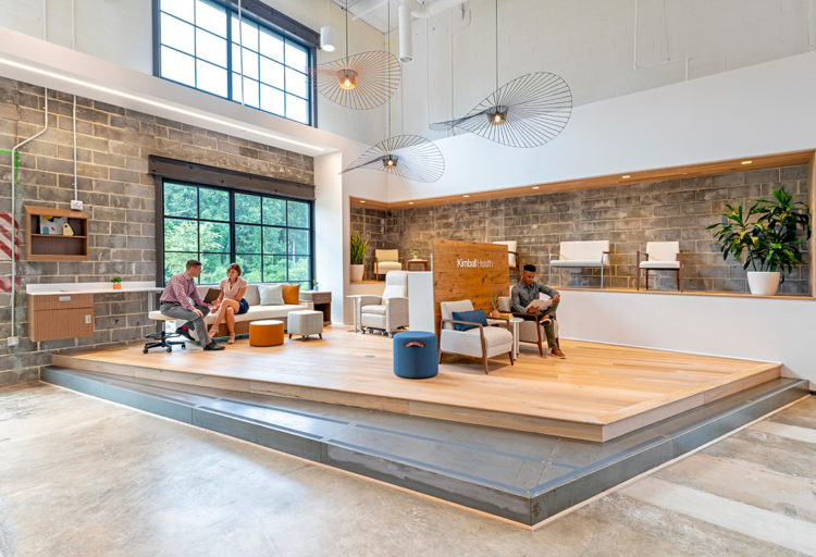 Kimball Health Alterna Casegoods showroom with seating and workspace on wood floor