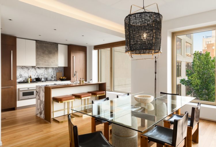 Global Lighting Z1 Black Paper Pendant in unit designed by Lenny Kravitz above dining table with open kitchen in background
