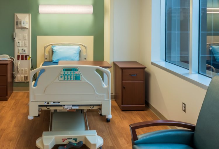 Alva's Eva Light 46" overbed version shown above patient bed in hospital room