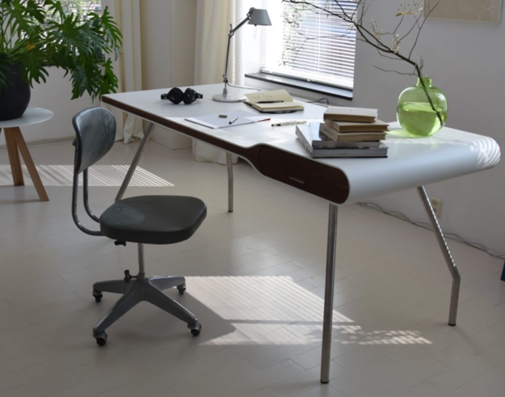 MIchiel van der Kley Icon Desk with Smoked Solid Oak iin office with chair and books and papers atop desk. 