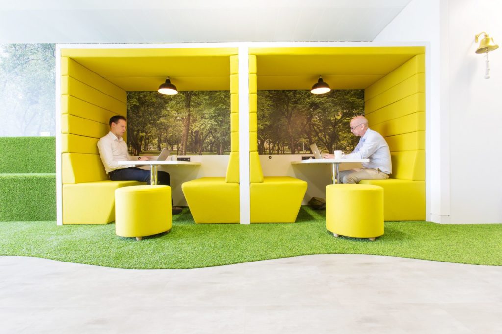 Spacestor Railway Carriage Classic yellow upholstery with white table adjoining units inhabited by one man in each