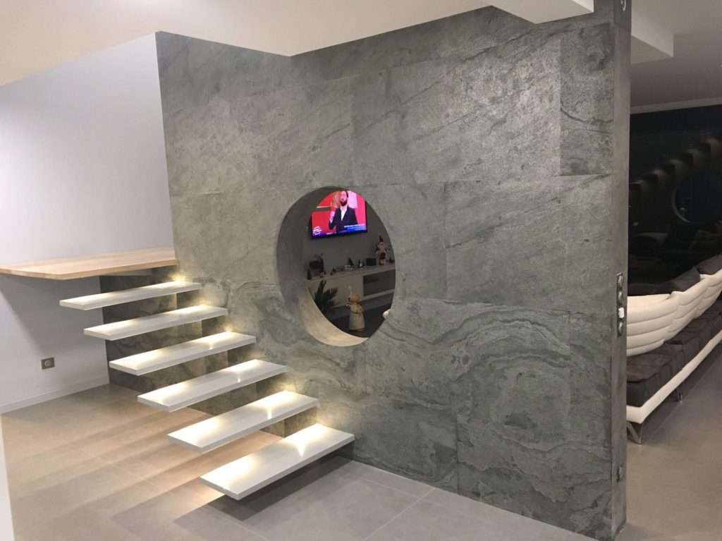 Slate-Lite grey with black veining on partition wall in entertainment room