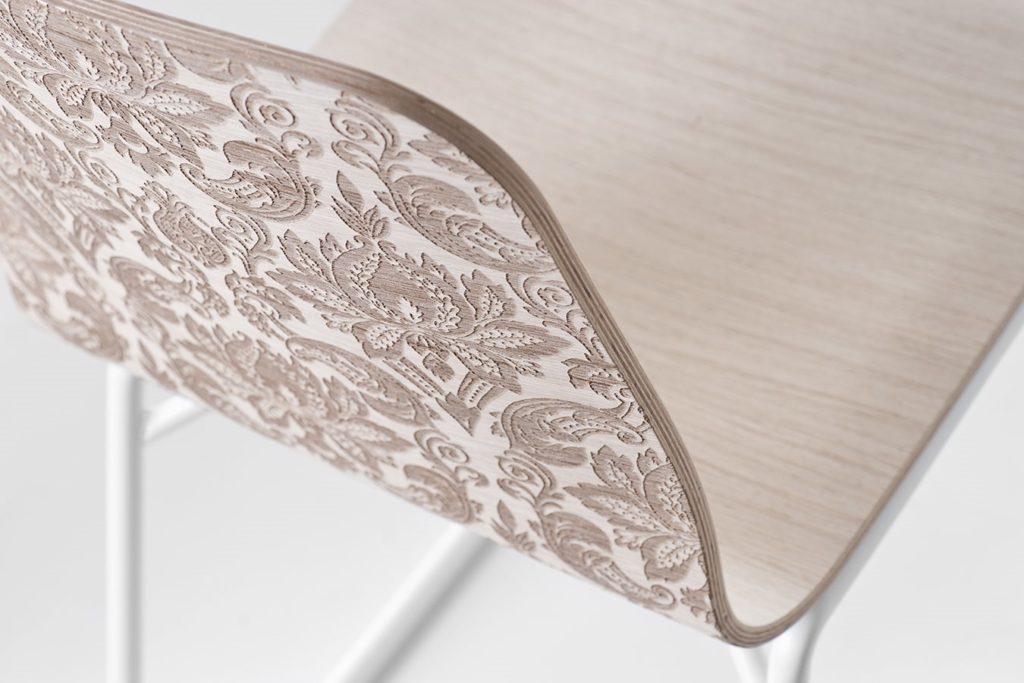 DVO's Tatto Chair detail of back with Western style design on wood laminate