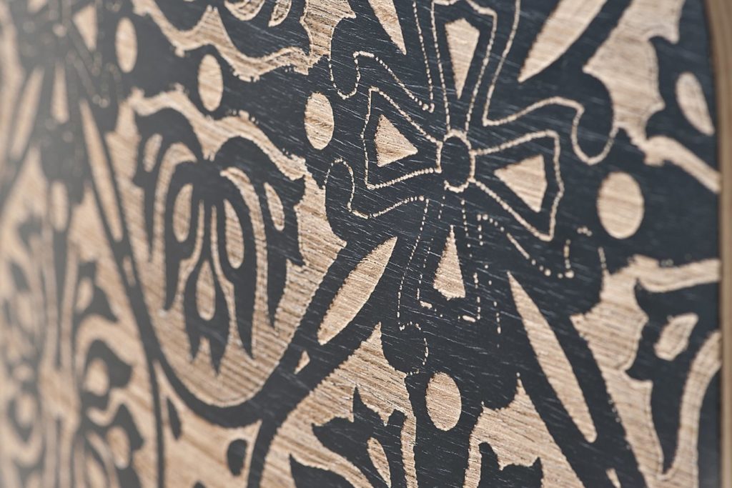 DVO's Tattoo Chair detail of intricate design with Georgia O'Keefe type geometric figures on wood
