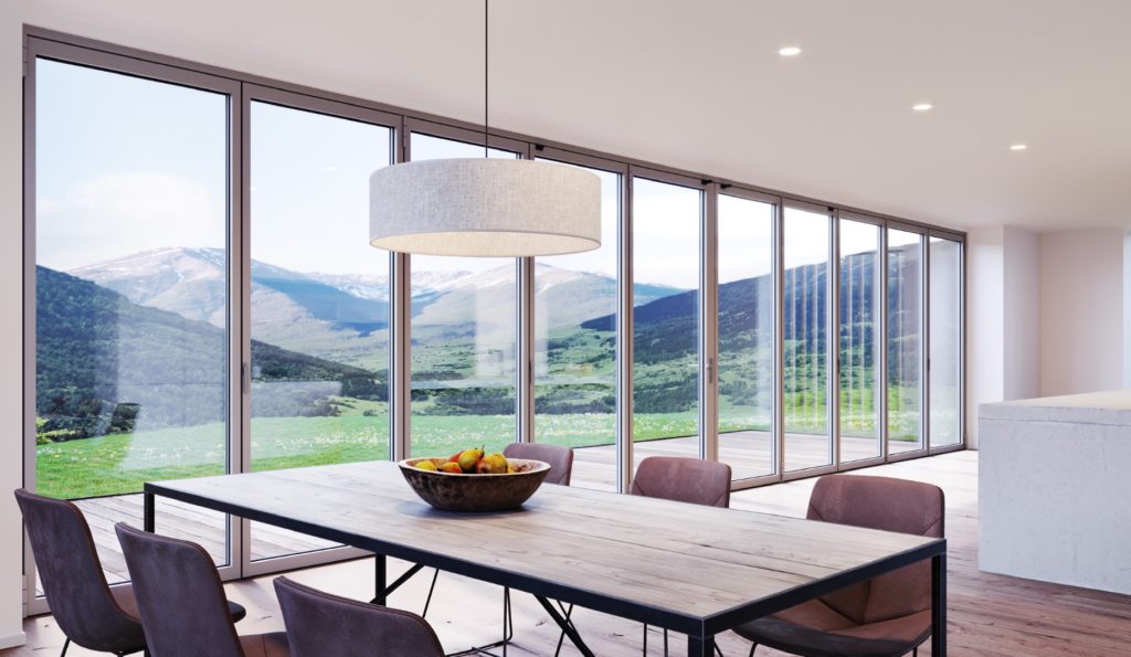 NanaWall's SL84 folding glass wall 10 panels in closed position looking from kitchen onto mountains