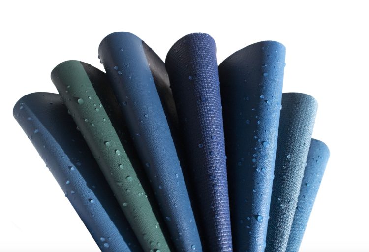 Otratex Moody Blues Textiles samples in blue shades and one green with beads of moisture