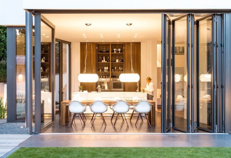 NanaWall's SL84 six panels opening onto kitchen view from outside looking in