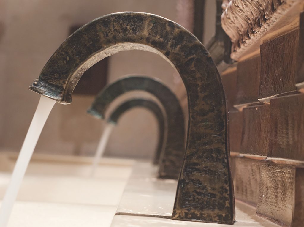 Smart Surfaces Sonoma Forge Sans Hands faucet three facuets close-up from side