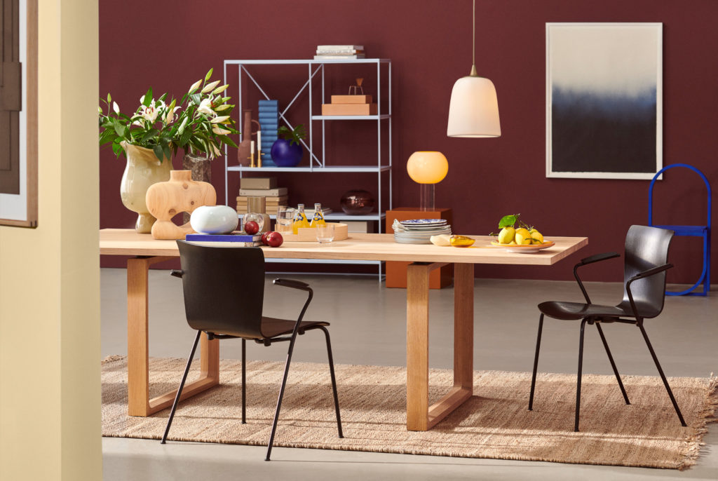 Vico Duo chair Black Ash and black base two chairs at kitchen table with fruit and plates