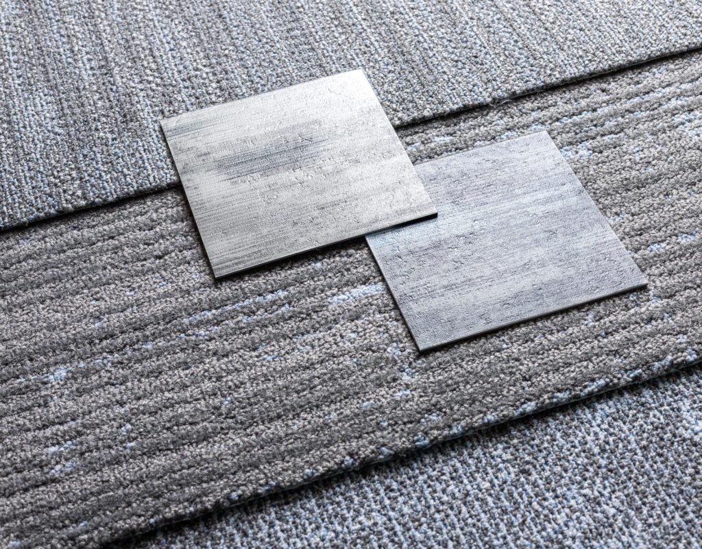 Tarkett Light Shift Collection close up of three carpet styles plus two samples of tile