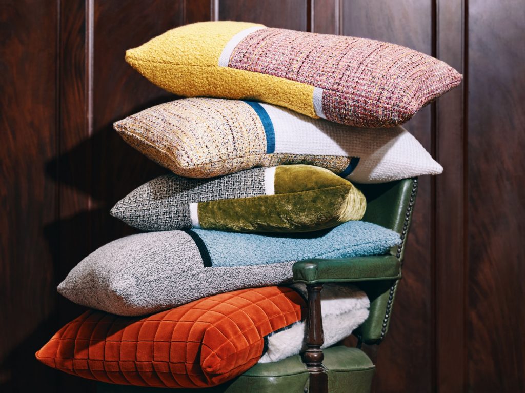 Toof and Toss Five Toss pillows stacked on chair