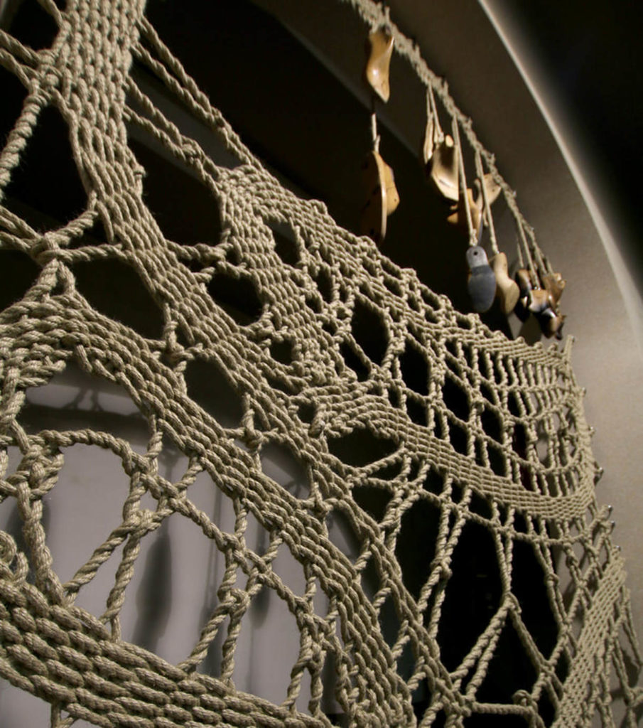 Mantzalin's Architectural Lace shoemaking piece with shoes hanging from lace