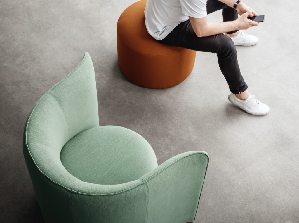 Hightower's Proto Lounge mint and orange ottoman with seated man
