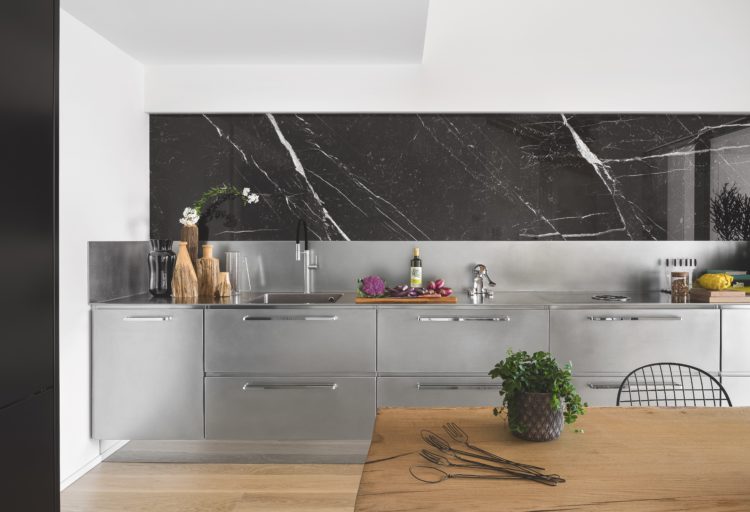 Atelier by Abimis stainless cooktop with partial view of table