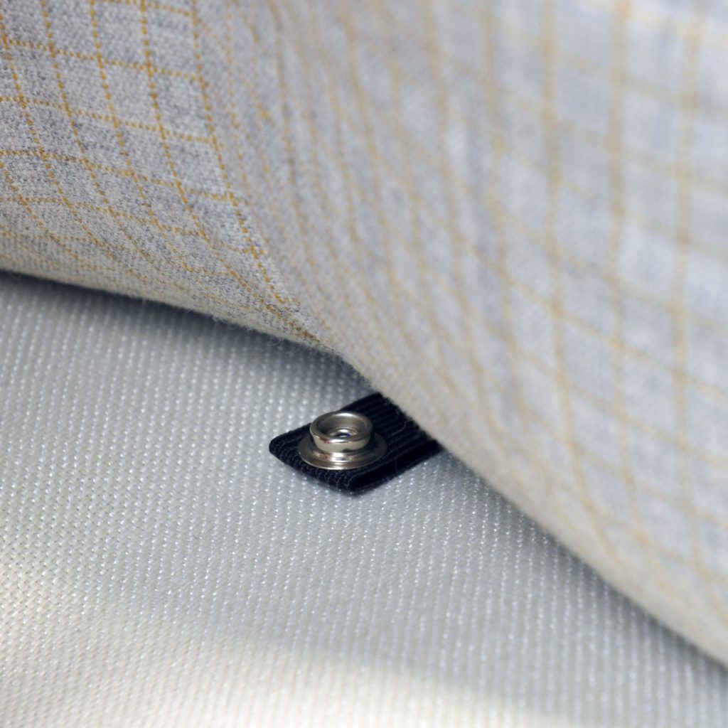Elements detail of pillow snapping onto seat