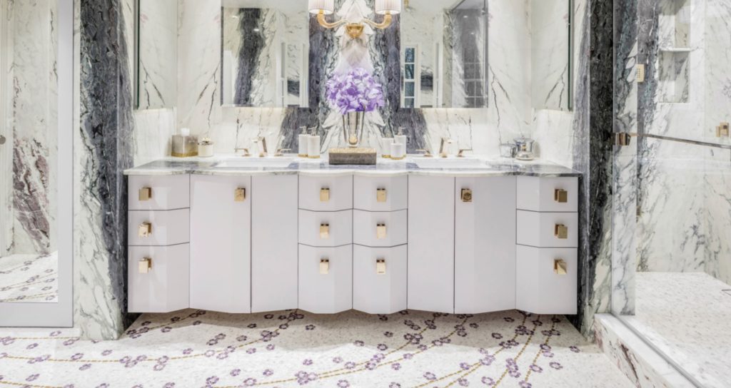Bookmatched slabs on bathroom wall whites and dark grays