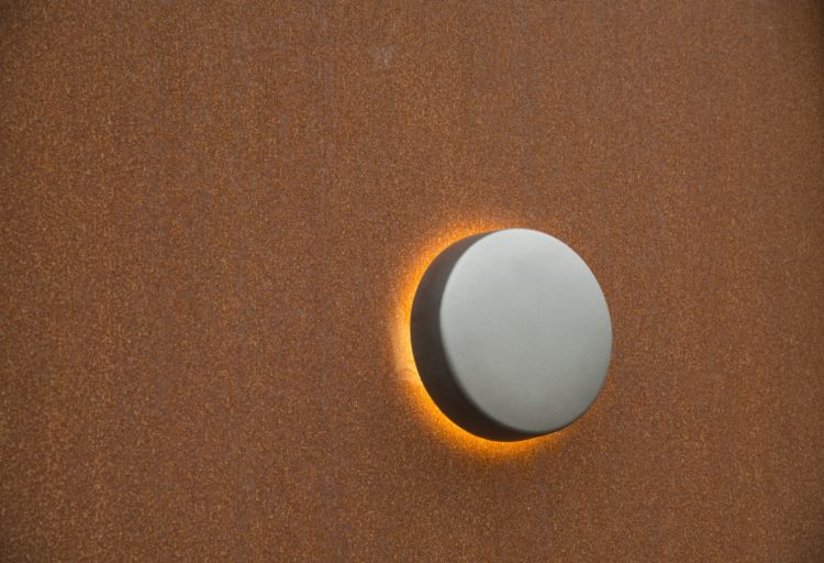 Motive lighting wall mount on orange wall