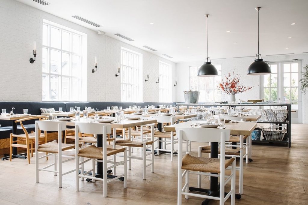 Original BTC Titan metal pendant two black above tables in bright restaurant
