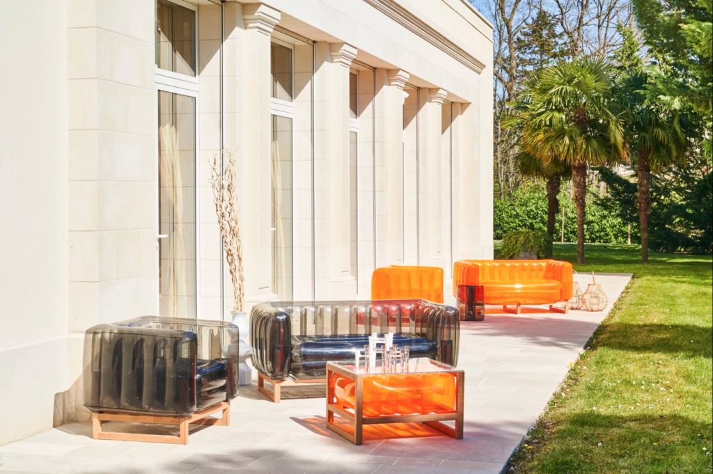 YOMI EKO daring seating orange and smoke outside building