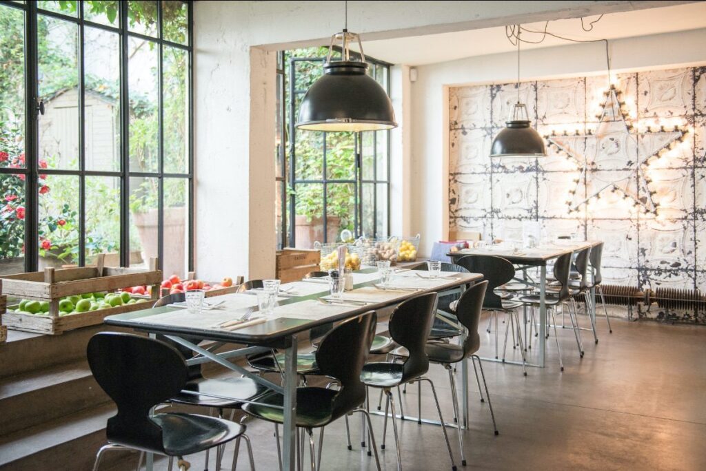 Original BTC Titan metal pendant two black over tables in French country restaurant