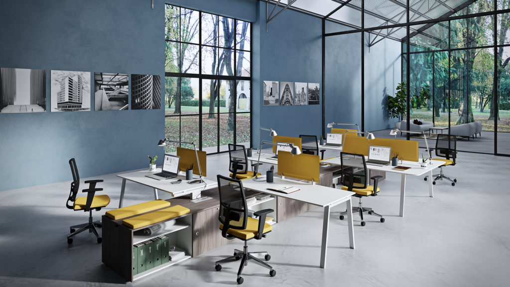 Vista Essence desks with white surface and black/yellow work chairs in modern office space with view of trees
