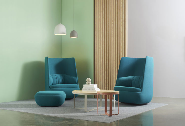 Hightower Gimbal Highback Rocker aqua two chairs with ottoman and low tables on gray rug with mint wall background