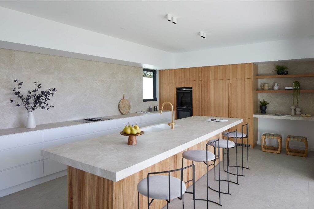 Ceramics of Italy Laminam Naturali Diamond Cream kitchen countertop in kitchen with wood cabinets and cream colored tile