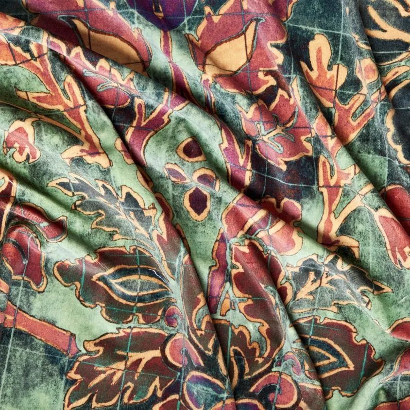 Andastra textile detail pattern with different floral forms on a grid background in bright colors like purple, teal, orange, and red