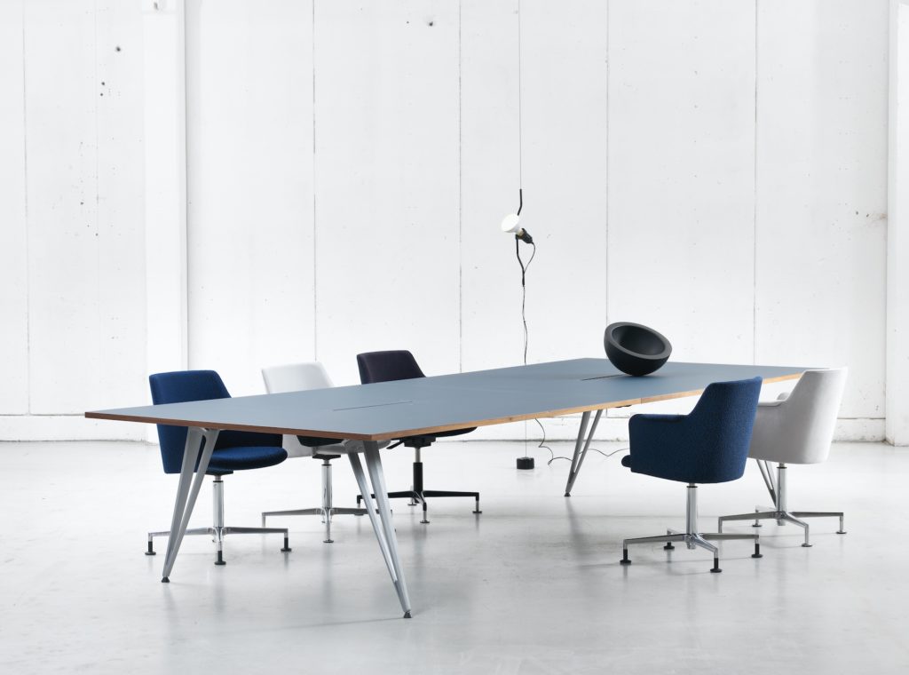 Attach table light blue with five chairs in white room
