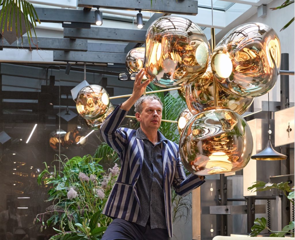 Tom Dixon Melt chandelier on brass stems with Dixon adjusting 