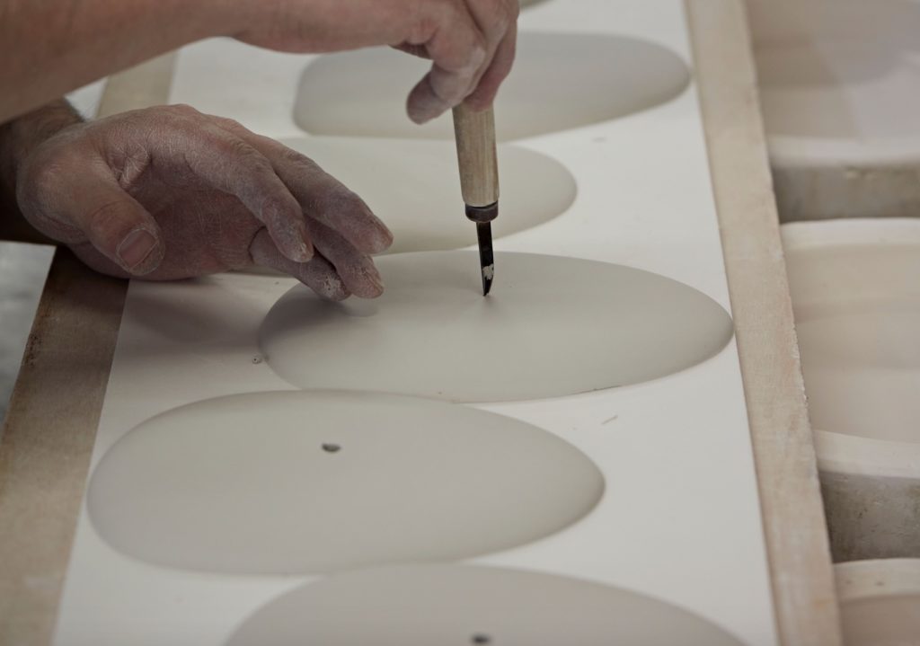 Original BTC Pebble Pendant manufacturing scoring each pebble form for attachment to structure