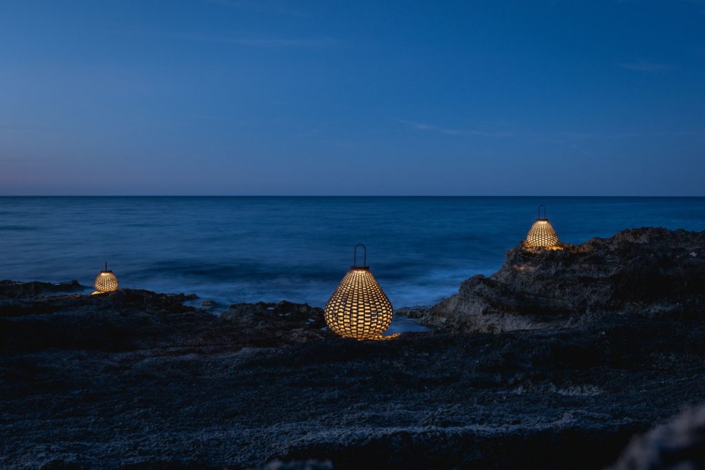 Boundless Living three Sparkler lamps illuminated on rocky beach