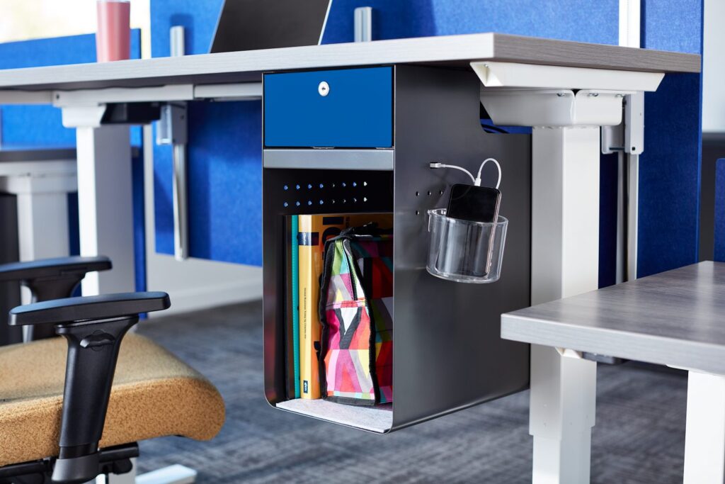 KI Bobbr undermount storage with blue drawer and gray edge of table visible with partial view of task chair with cork seat