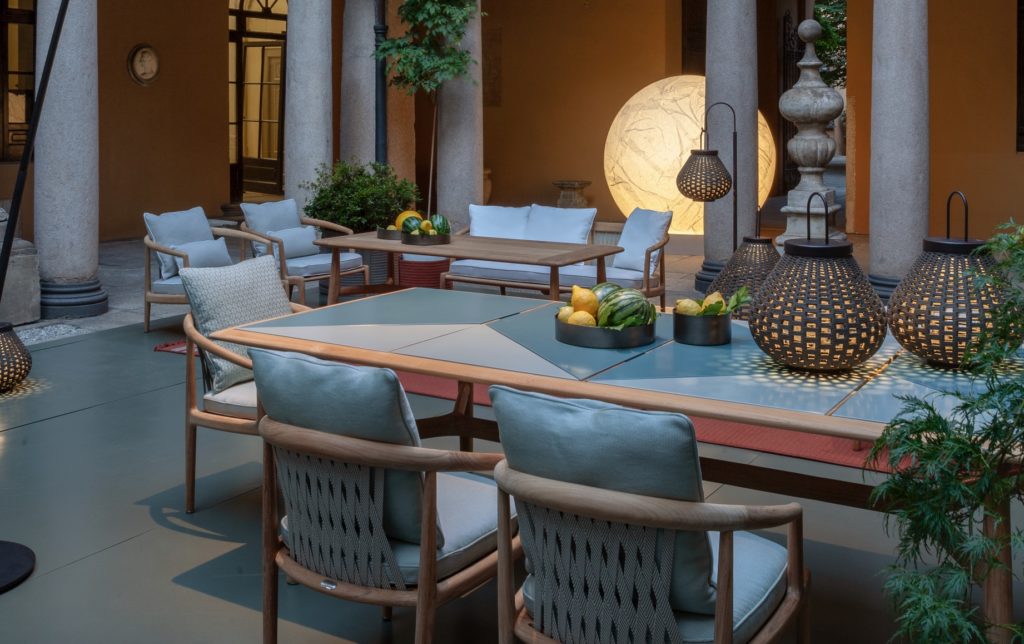 Boundless Living Solaria collection chairs and table with Sparkler lamps on terrace with white pillars in background
