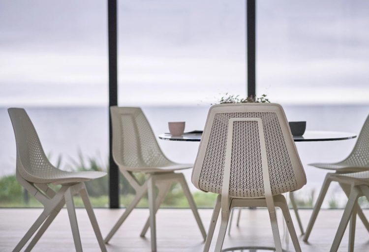 Noho Move Chair four chairs in white in front of window with ocean view