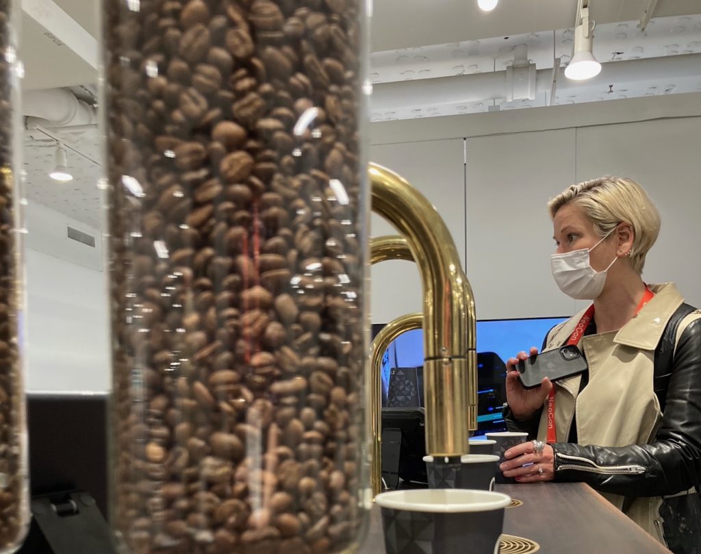TopBrewer live view with hopper in foreground and woman with phone