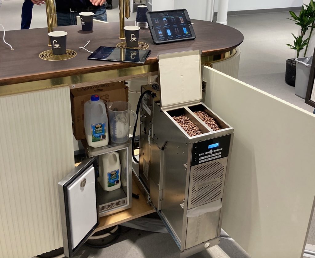 TopBrewer undercabinet view showing machine, bean hopper, and milk chiller
