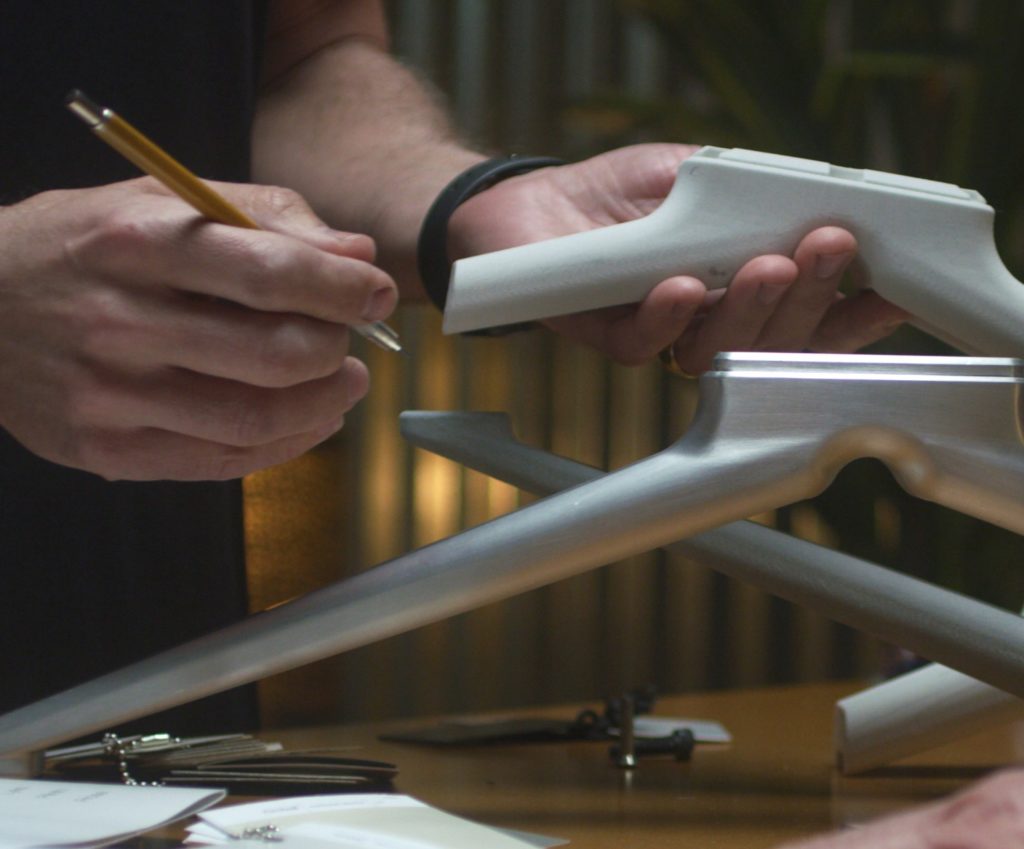 EverySpace Y-shaped base element detail with hands holding a pencil
