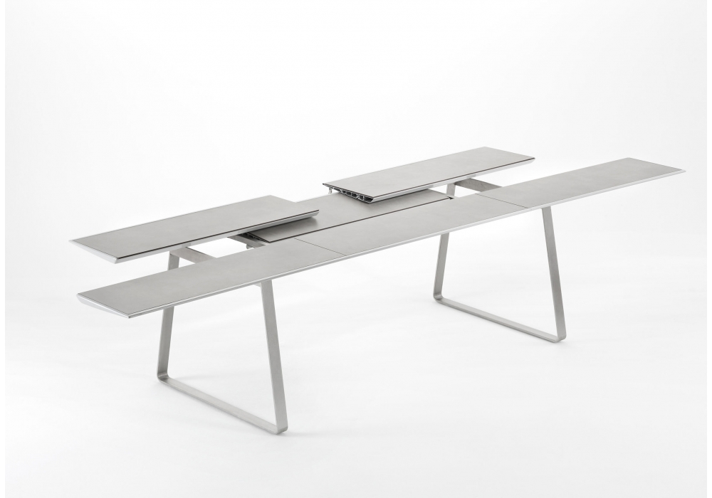 Extrados table in adjusting position with leaves being moved to make table longer