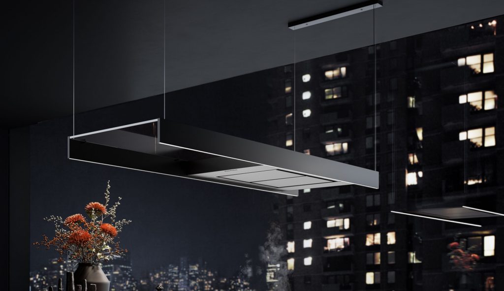 Light kitchen hood angled view in fancy kitchen with outdoor view of neighboring building