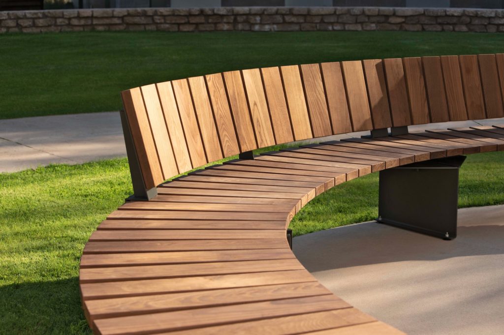 Link detail of piano key arced bench on grassy area