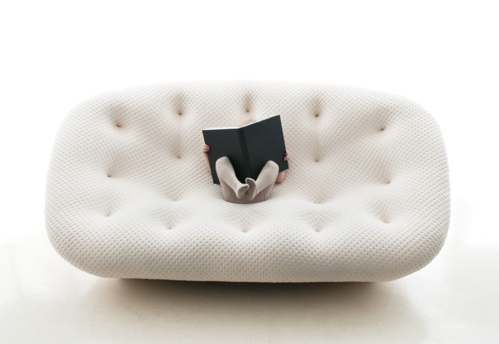 Ploum in white with child reading