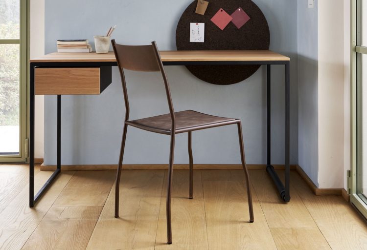 Macis Table Desk with wood top in room with blue wall and windows