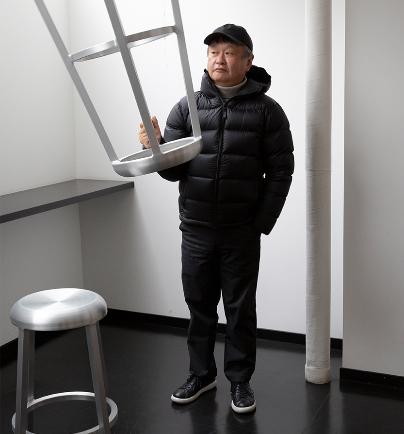 Emeco Za Stool with designer holding one and one on floor